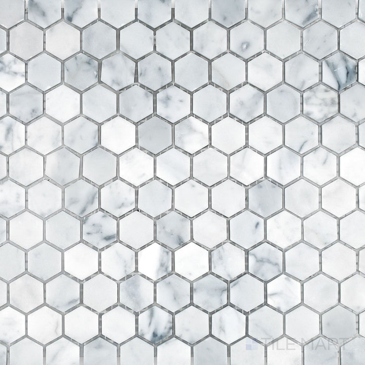 Flat lay of White Carrara Marble 1-inch hexagon honed mosaic, showcasing small matte hex tiles perfect for adding subtle texture to walls or floors