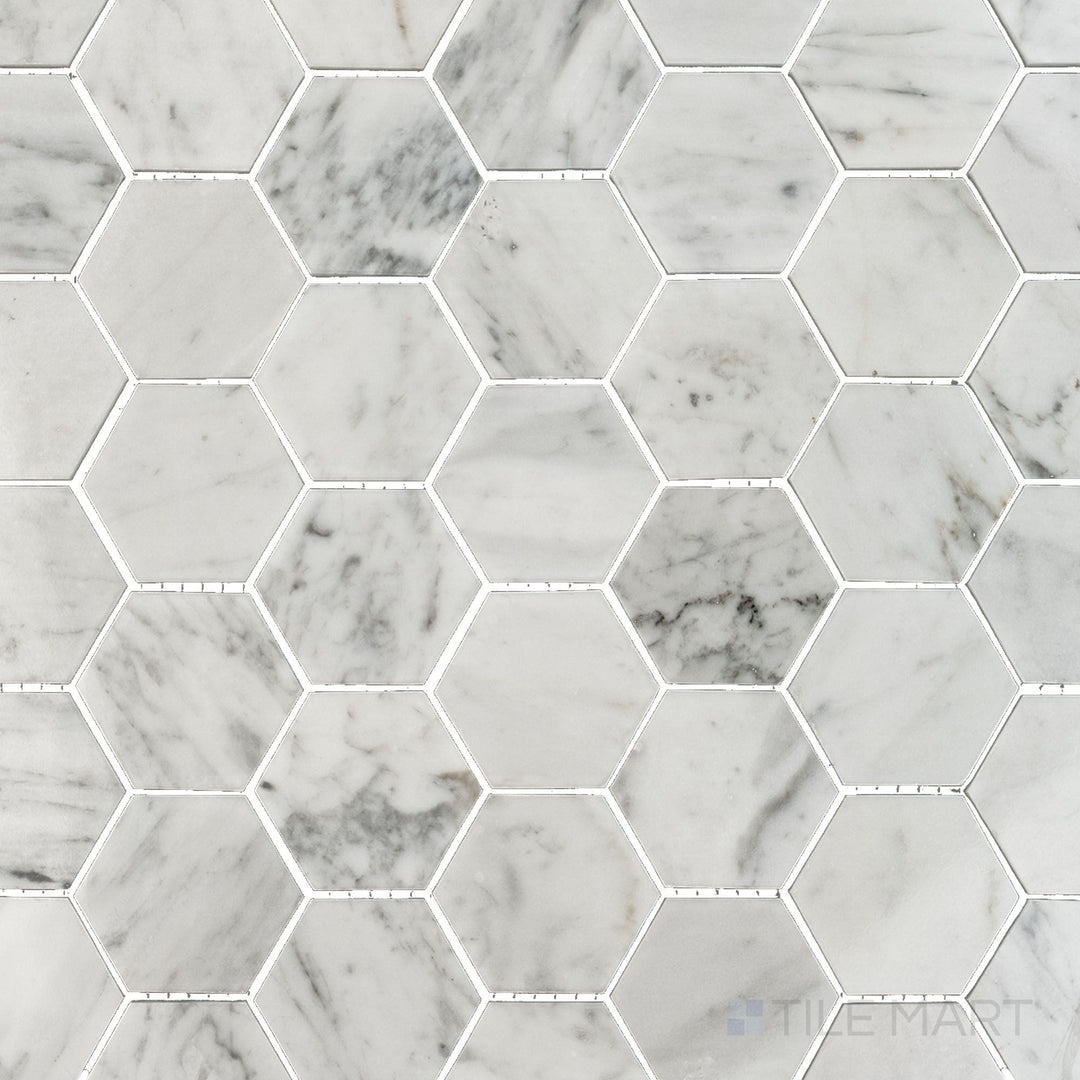 Flat top view of White Carrara Marble 2-inch hexagon polished mosaic tiles, offering a bright reflective surface with a bold geometric pattern