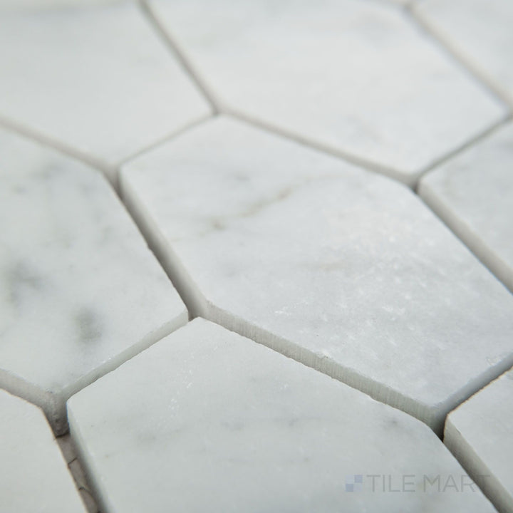 Angled view of White Carrara Marble elongated hexagon honed mosaic highlighting matte marble in a modern elongated hexagon design
