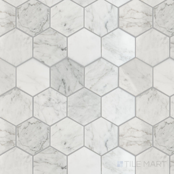 Overhead shot of White Carrara Marble 3-inch hexagon polished mosaic tiles, featuring a glossy surface and bold geometric appeal