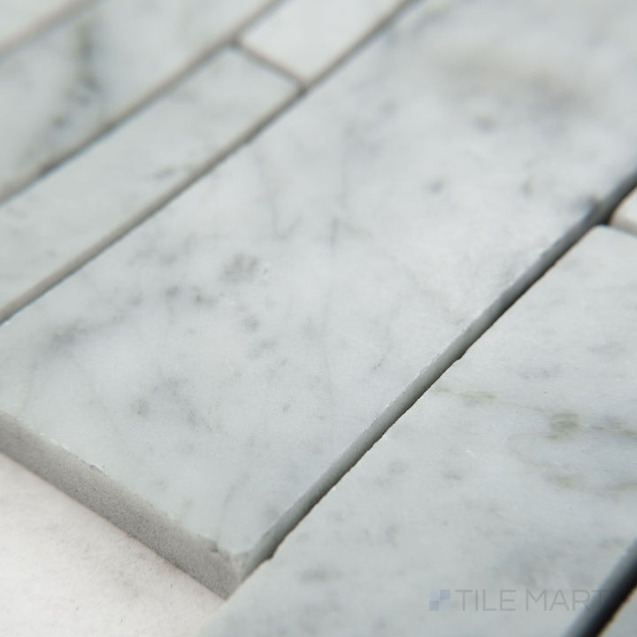 Tile corner display of White Carrara Marble linear honed mosaic featuring soft matte marble strips set in a clean, linear design