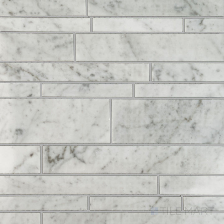 Flat lay of White Carrara Marble linear polished mosaic, showcasing narrow bright marble strips laid in a clean, modern grid layout