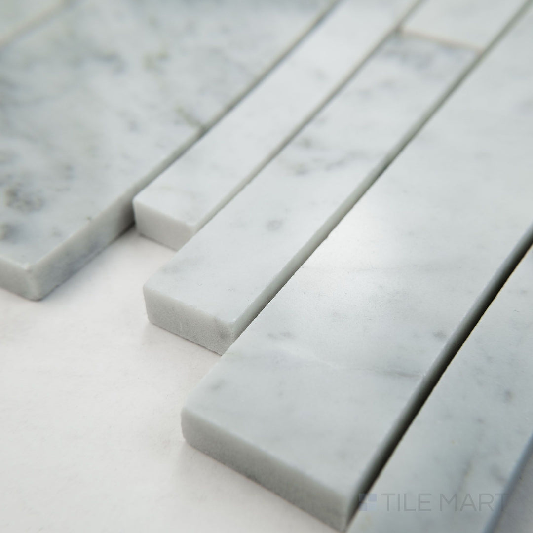 Angled view of White Carrara Marble linear polished mosaic highlighting sleek glossy marble strips aligned in a modern linear pattern