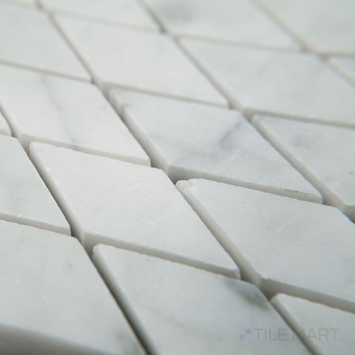 Tile corner display of White Carrara Marble rhomboid honed mosaic showcasing matte marble diamonds arranged in an eye-catching pattern