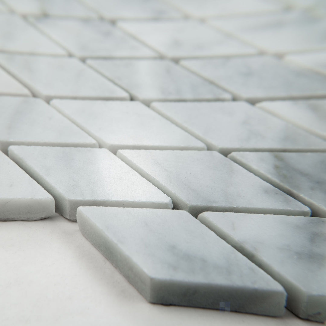 Tile shown from corner angle of White Carrara Marble rhomboid polished mosaic highlighting glossy marble in a unique rhombus layout