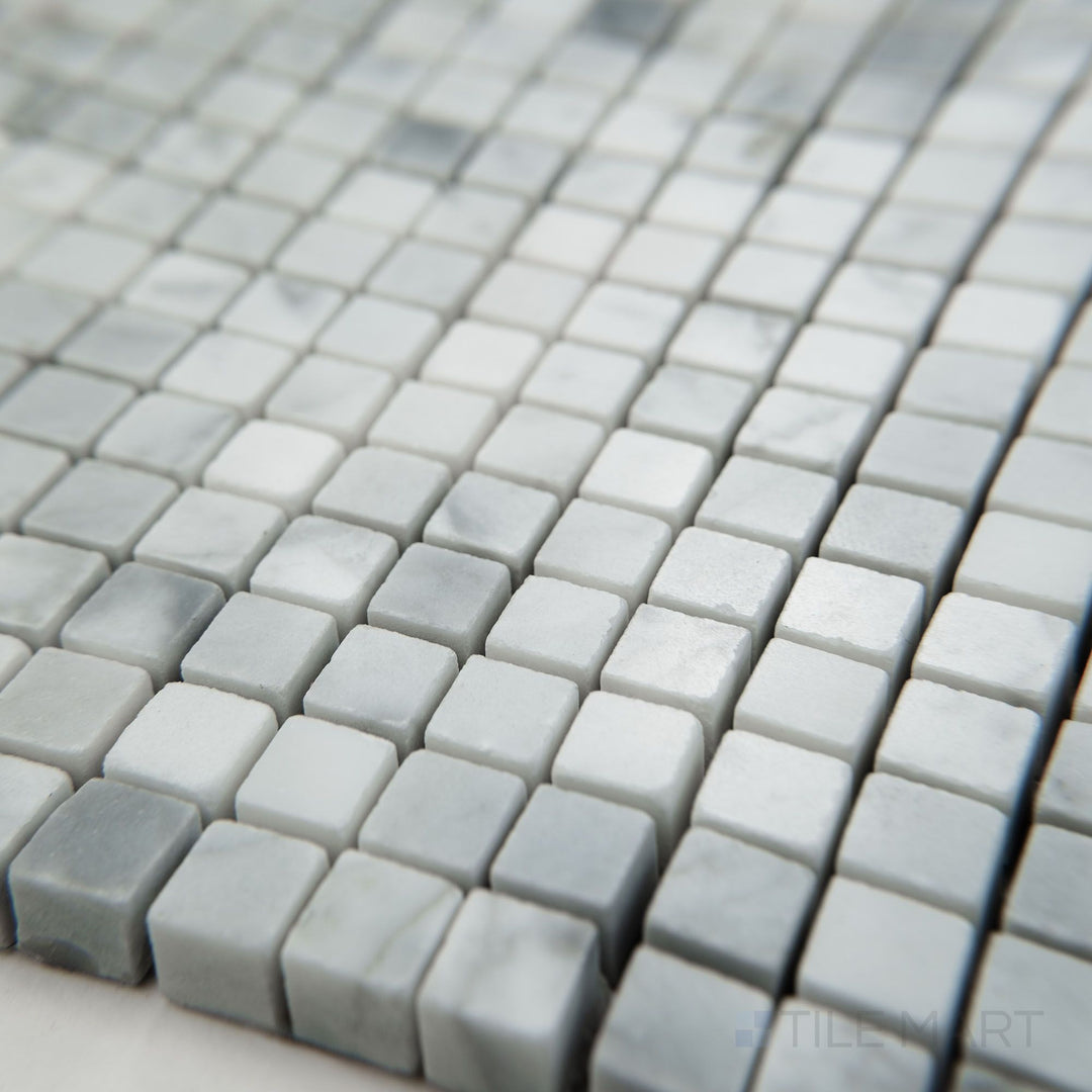 Angled view of White Carrara Marble 3/8" square polished mosaic featuring glossy marble tiles in a precise miniature square pattern