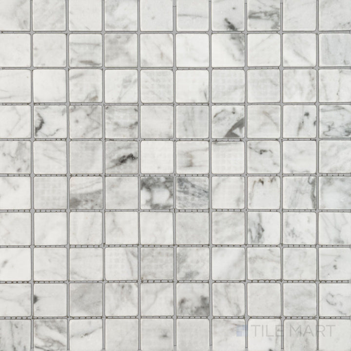 Top-down image of White Carrara Marble 1" square tumbled mosaic, showcasing lightly textured marble tiles with a rustic, natural feel