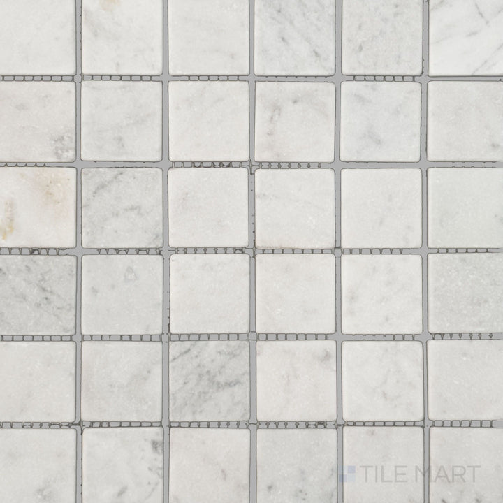 Top view of White Carrara Marble 2" square tumbled mosaic, highlighting naturally textured marble tiles offering a relaxed, organic look