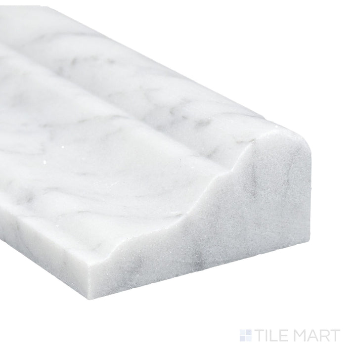 Corner close-up of White Carrara Marble 2x12 honed grand chair rail showing matte surface and elegant veining.