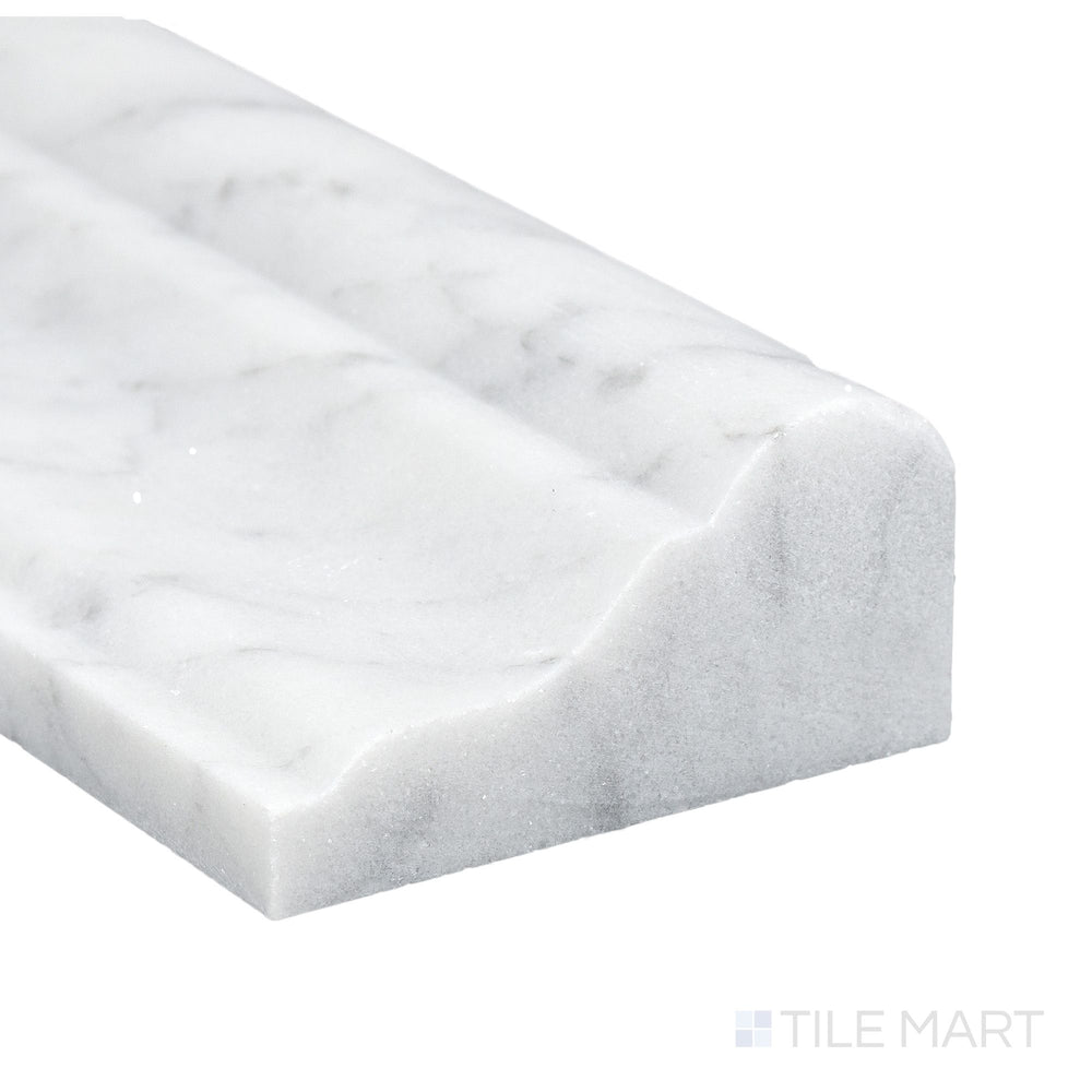 Corner close-up of White Carrara Marble 2x12 honed grand chair rail showing matte surface and elegant veining.