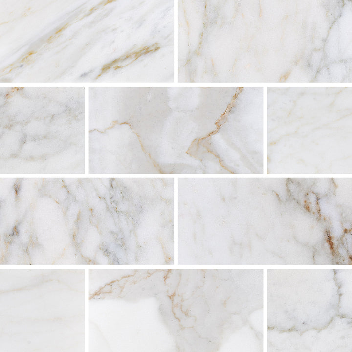 Overview shot of Calacatta Gold Marble 3x6 Honed Tile, highlighting its elegant white background with bold gold veining—ideal for upscale wall and backsplash designs.