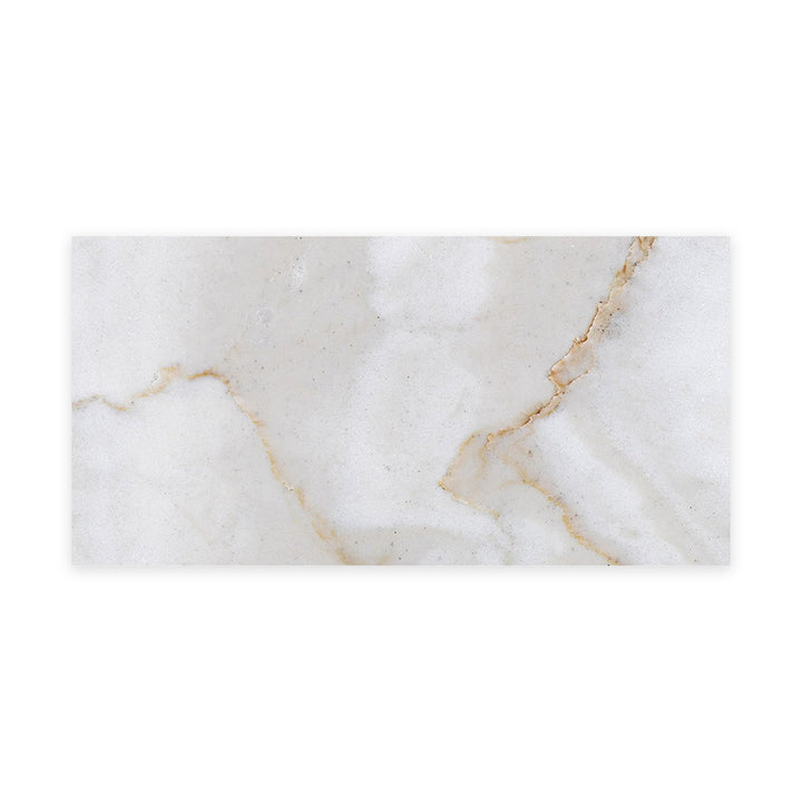 Honed Calacatta Gold Marble tile in a 3x6 format viewed from above, showcasing elegant gold veining on a soft white background for timeless appeal.
