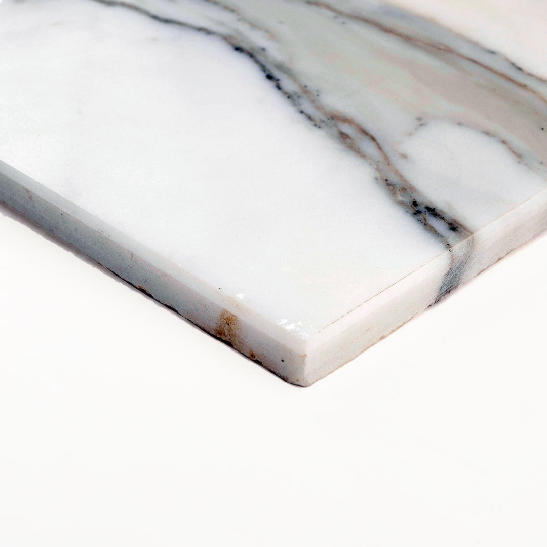 Corner shot of Calacatta Gold Marble 3x6 tile in honed finish, showcasing soft matte surface with gentle veining and natural stone elegance.