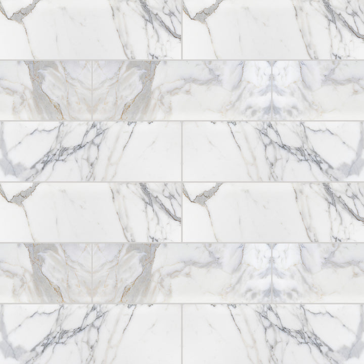 Calacatta Gold Marble 4X12 honed tiles shown in a comprehensive arrangement, capturing tonal shifts and linear movement.