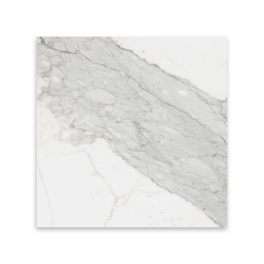 Seen in a top view, the 12x12 Calacatta Gold Marble tile with honed finish features broad strokes of golden veining, ideal for spacious applications.