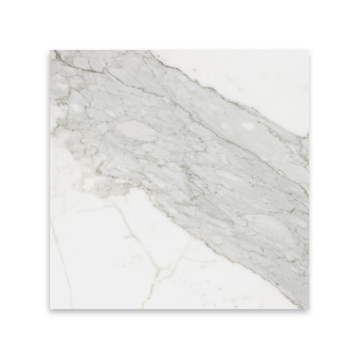 Seen in a top view, the 12x12 Calacatta Gold Marble tile with honed finish features broad strokes of golden veining, ideal for spacious applications.