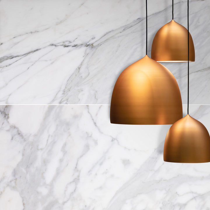 Three bronze pendant lights on a marble background