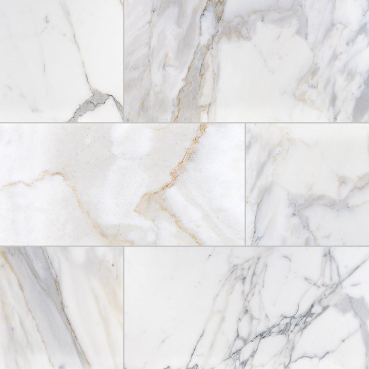 Calacatta Gold Marble 12X24 honed tiles displayed in a multi-piece layout emphasizing veining flow and matte texture.