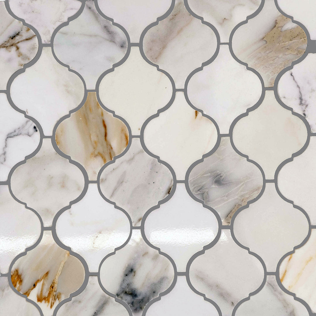 Top arrangement of Calacatta Gold Marble 4" Lantern/Arabesque honed mosaic pieces showing interlocking layout.