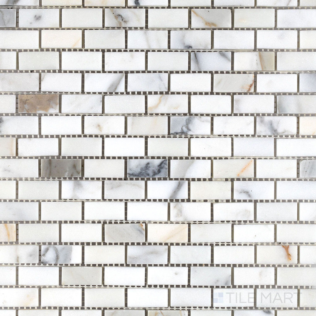 Calacatta Gold Marble 5/8x1-1/4 honed brick mosaic tiles shown in a wide view highlighting classic marble elegance and compact layout.