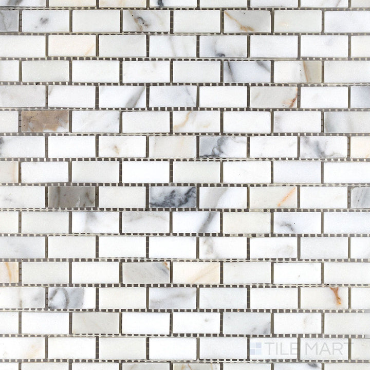 Calacatta Gold Marble 5/8x1-1/4 honed brick mosaic tiles shown in a wide view highlighting classic marble elegance and compact layout.