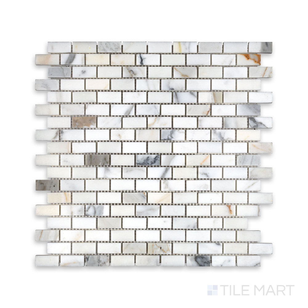 Overhead view of Calacatta Gold Marble 5/8 by 1-1/4 inch brick mosaic in a honed finish, offering a refined small-format tile for intricate surface design.