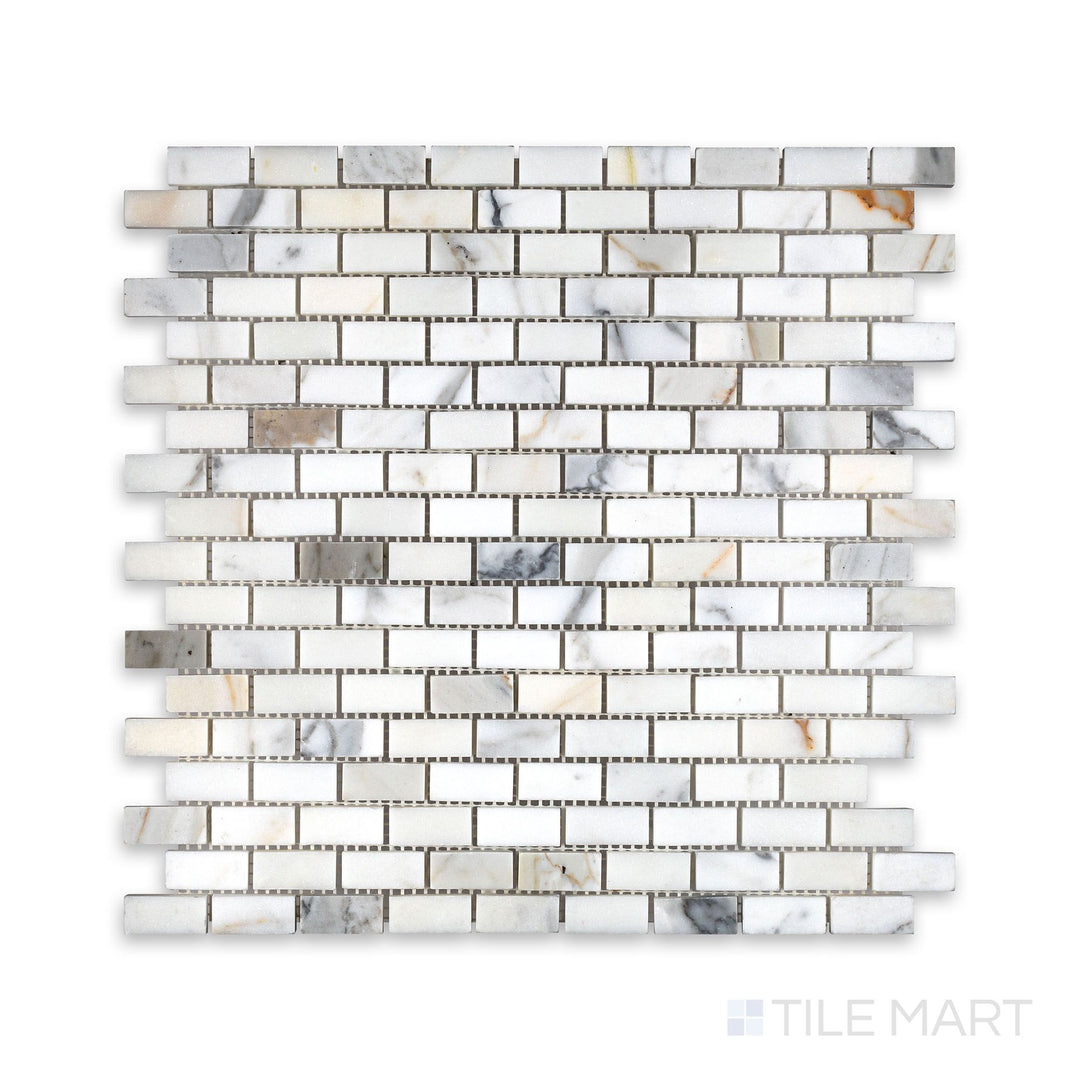 Overhead view of Calacatta Gold Marble 5/8 by 1-1/4 inch brick mosaic in a honed finish, offering a refined small-format tile for intricate surface design.