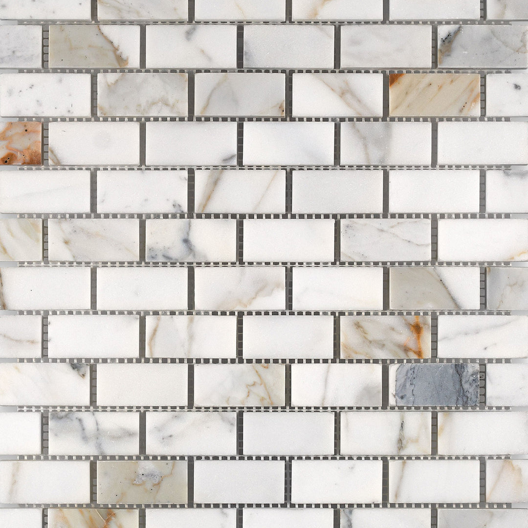 Calacatta Gold Marble 1x2 brick honed mosaic tiles arranged to exhibit a timeless pattern and smooth matte surface.