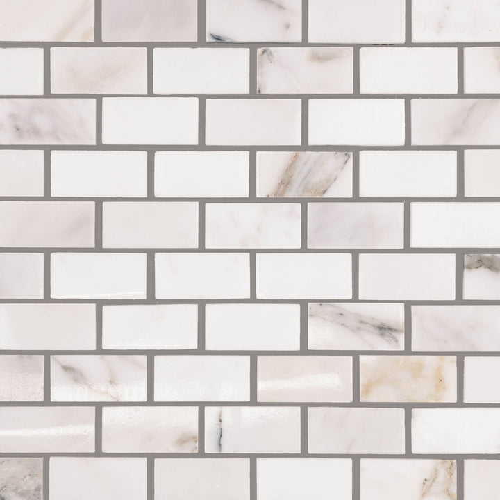 Overview view of Calacatta Gold Marble 1x2 Brick Polished Mosaic, showing a classic brick layout with radiant white marble and rich gold accents.