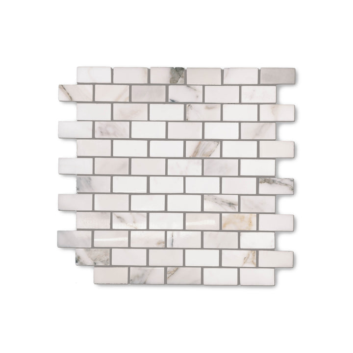 Top-down view of Calacatta Gold Marble 1x2 brick mosaic with a polished finish, offering a sleek layout enriched by golden veining on white marble.