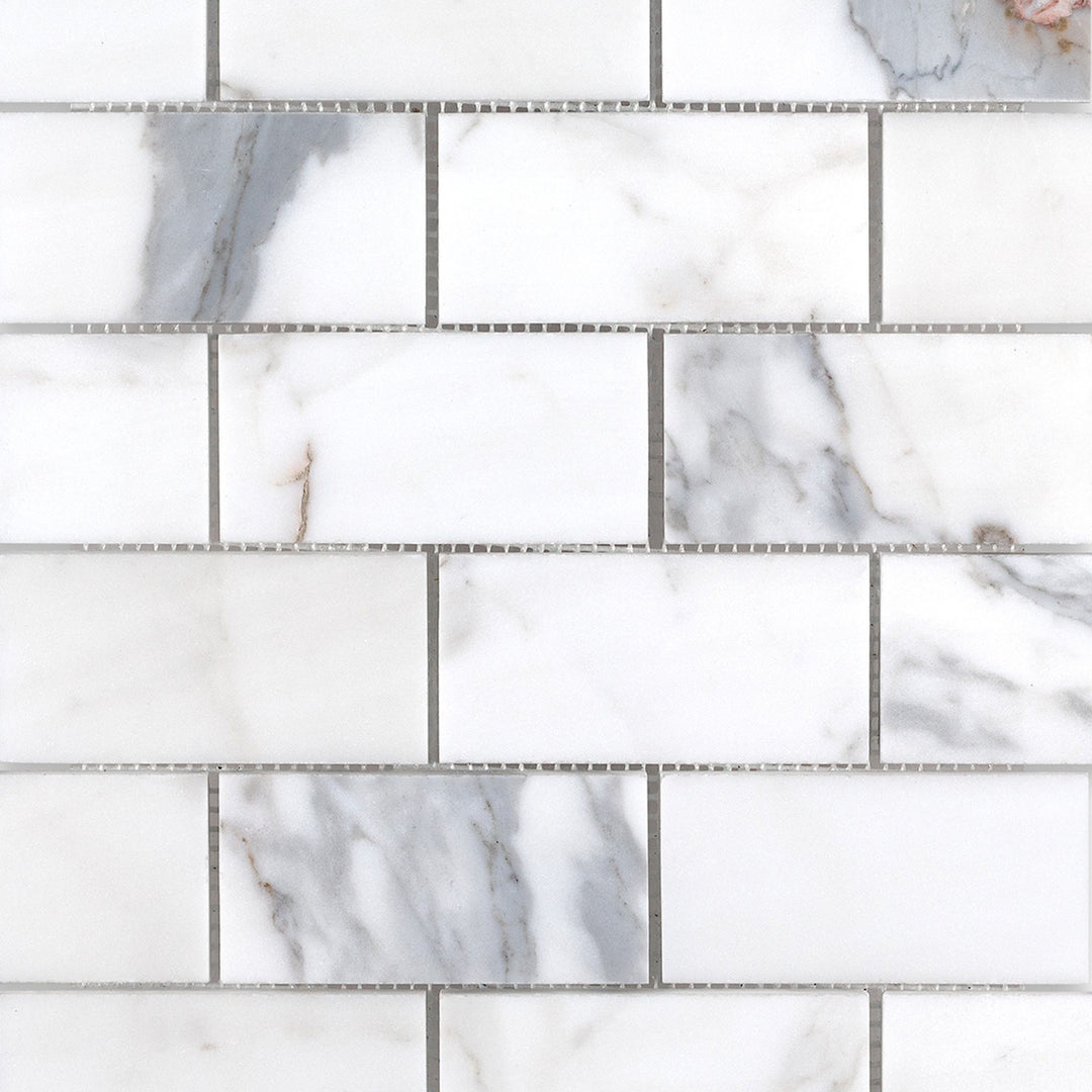 Full-view of Calacatta Gold Marble 2x4 brick honed mosaic tiles showcasing larger format with subtle honed finish.