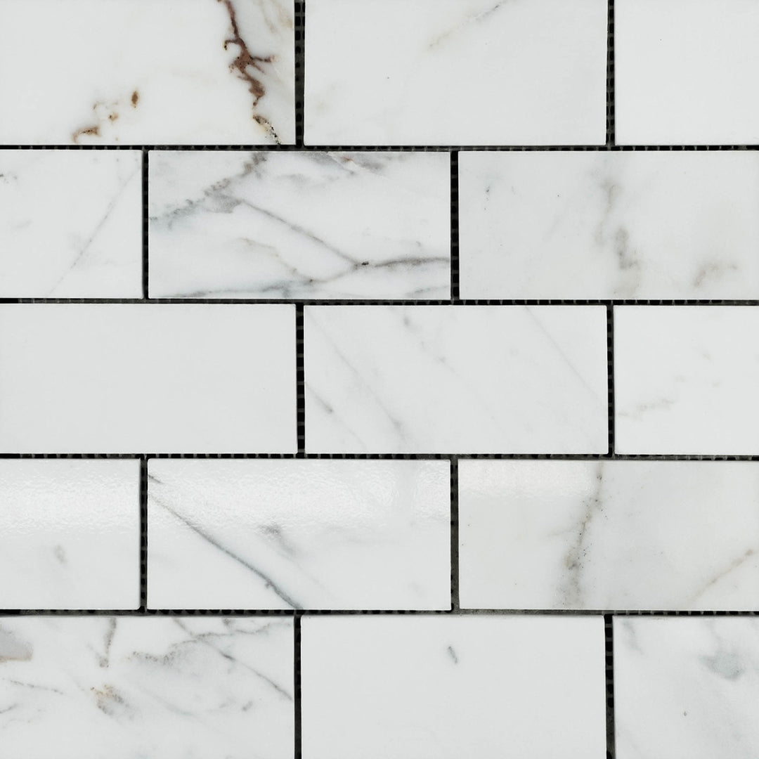 Calacatta Gold Marble 2x4 brick polished mosaic overview featuring bold veining and a radiant surface.