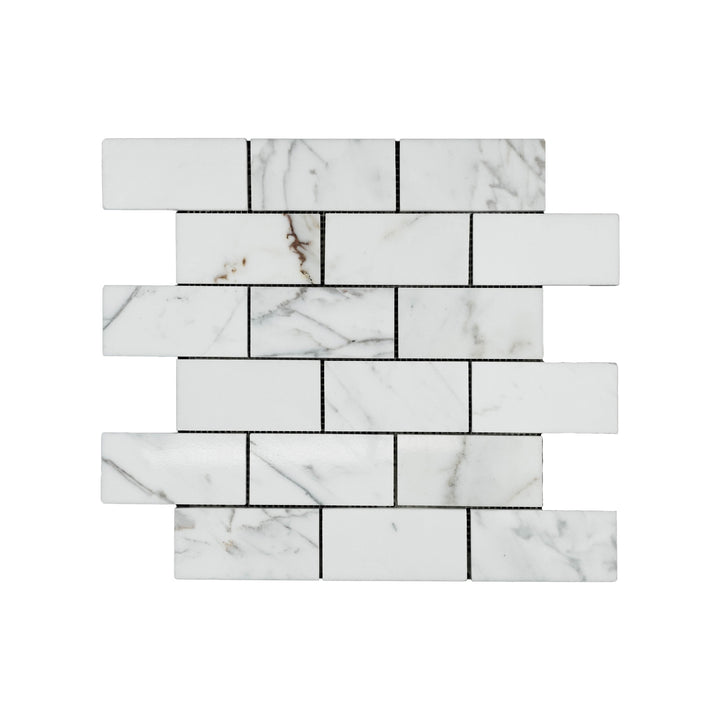 Polished Calacatta Gold Marble 2x4 brick mosaic viewed from above, capturing a glossy surface and refined brickwork ideal for classic designs.
