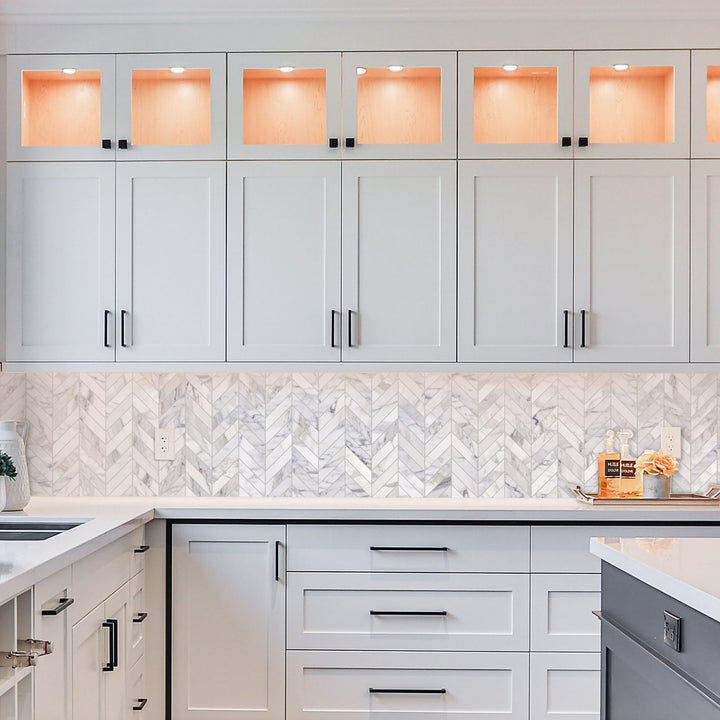 Modern kitchen with gray cabinets and marble backsplash