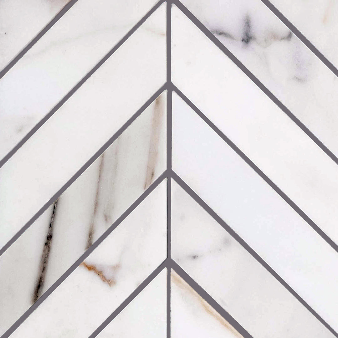 Chevron-patterned Calacatta Gold Marble honed mosaic shown in full layout to display dynamic angles and elegant matte texture.