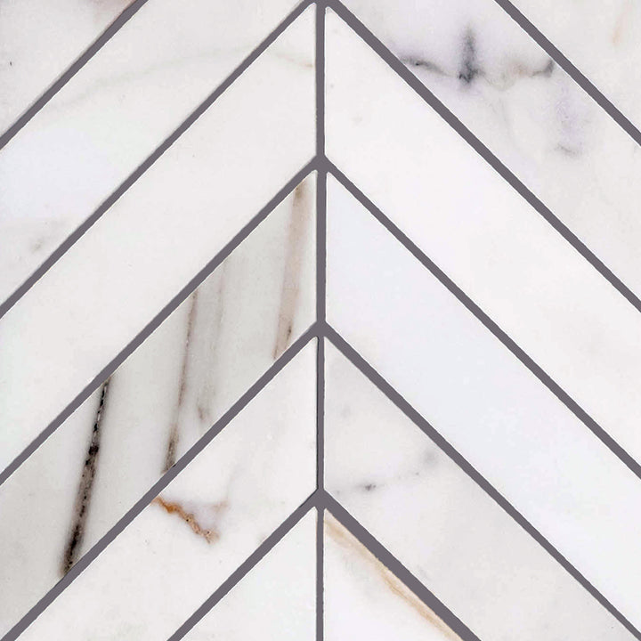 Chevron-patterned Calacatta Gold Marble honed mosaic shown in full layout to display dynamic angles and elegant matte texture.