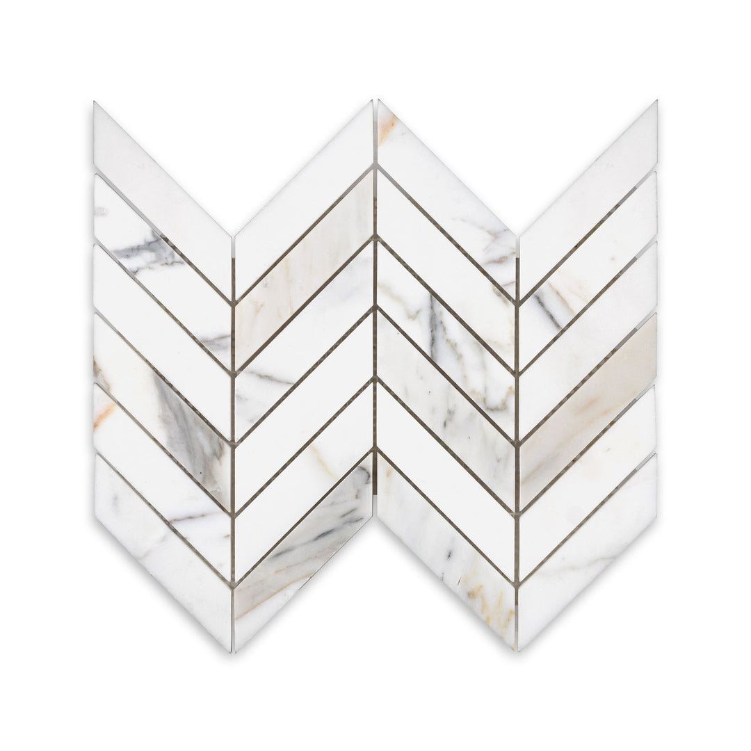 Overhead shot of Calacatta Gold Marble chevron mosaic in honed finish, featuring a dynamic pattern and gentle sheen with natural gold veining.