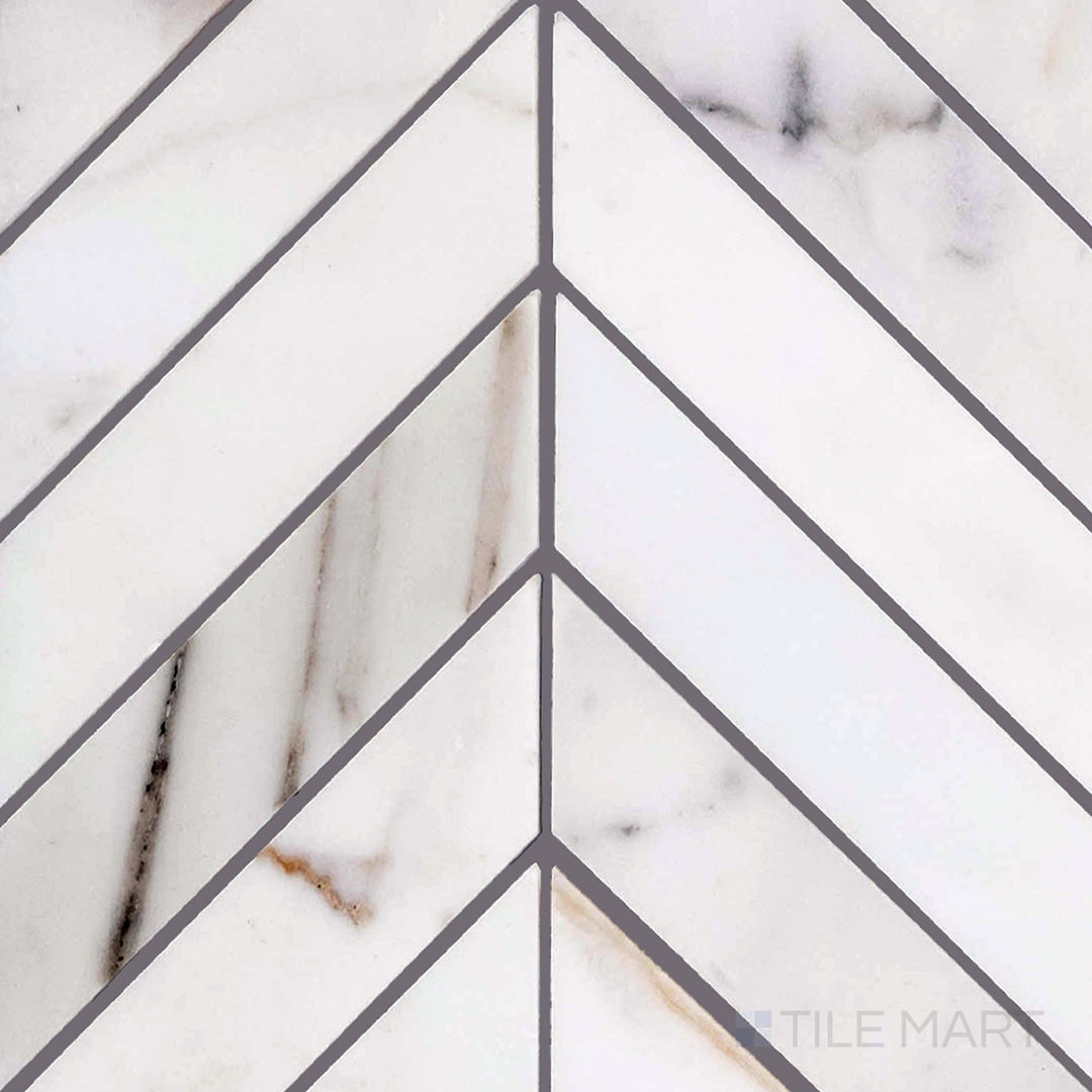 Overview of Calacatta Gold marble chevron polished mosaic tile, with striking V-shaped pattern and dramatic golden veining.