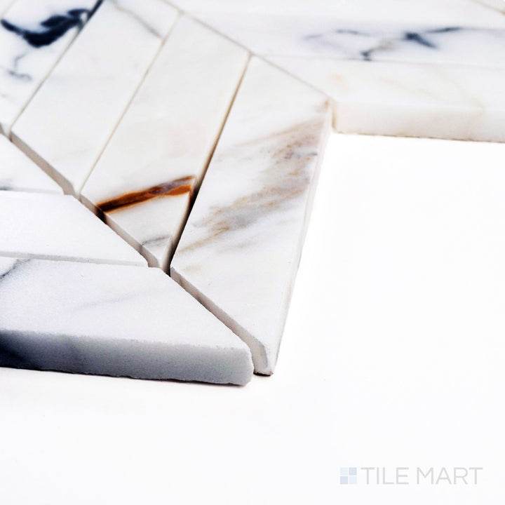 Corner close-up of Calacatta Gold Marble chevron polished mosaic showing elegant veining and glossy white finish.