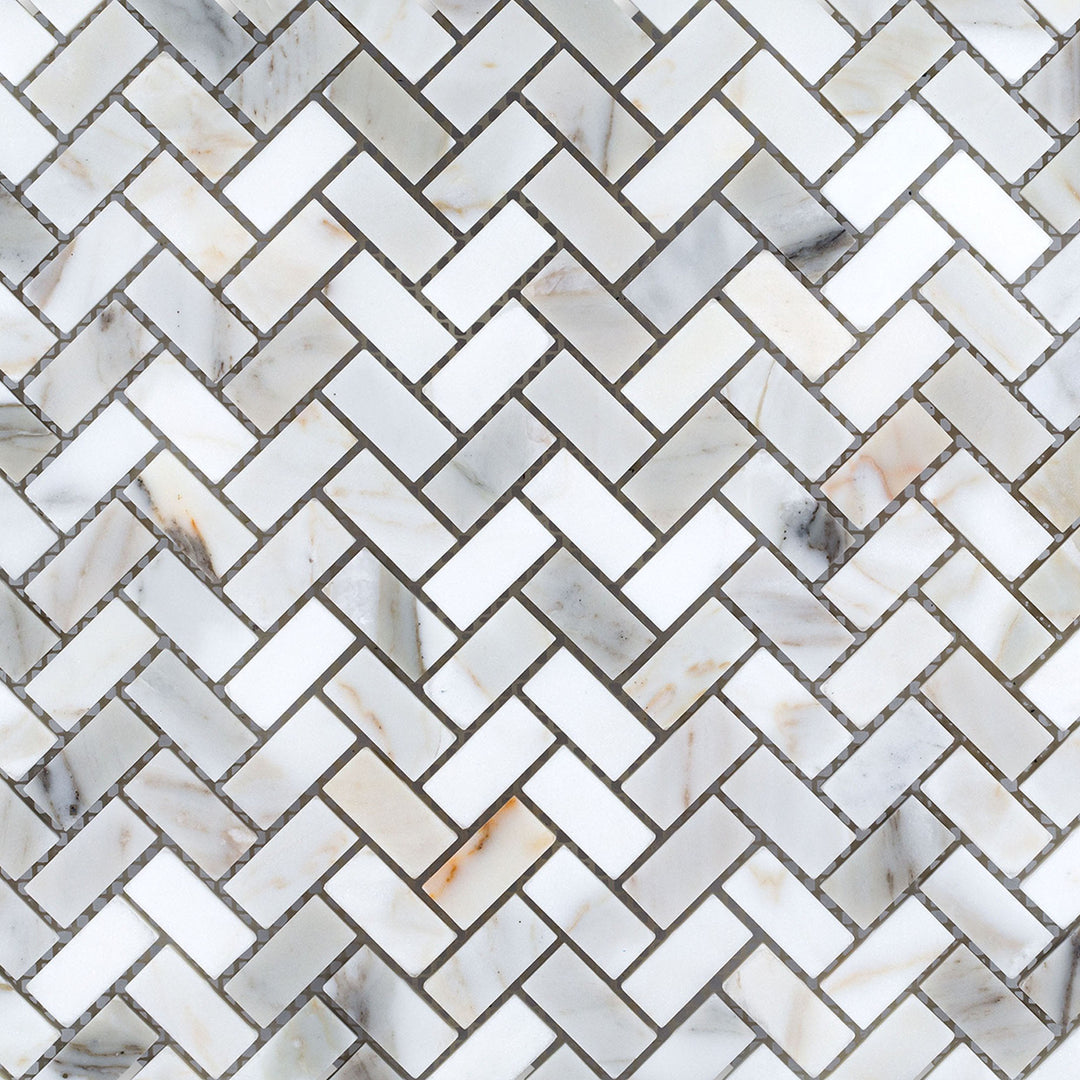 Overview of Calacatta Gold Marble 5/8x1-1/4 herringbone honed mosaic with intricate layout and soft natural finish.