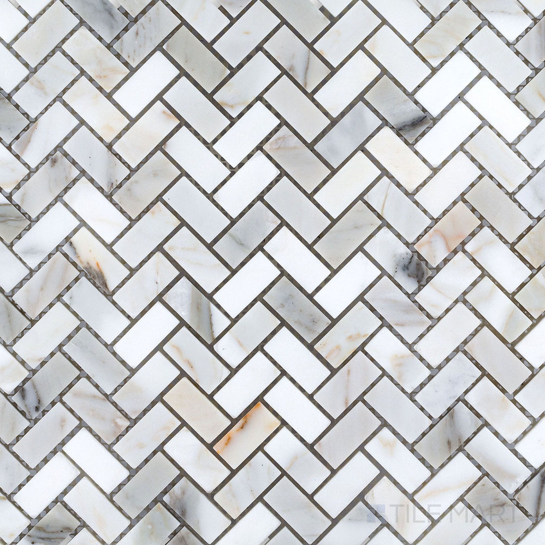 Calacatta Gold marble 5/8x1-1/4 herringbone polished mosaic tile shown in layout, presenting a refined zigzag design with classic white-and-gold tones.