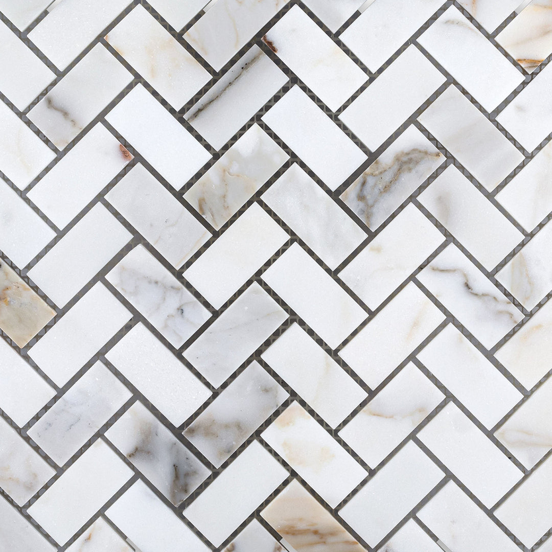 Overview of Calacatta Gold Marble 1x2 herringbone honed mosaic showcasing a refined zigzag pattern and soft matte finish.