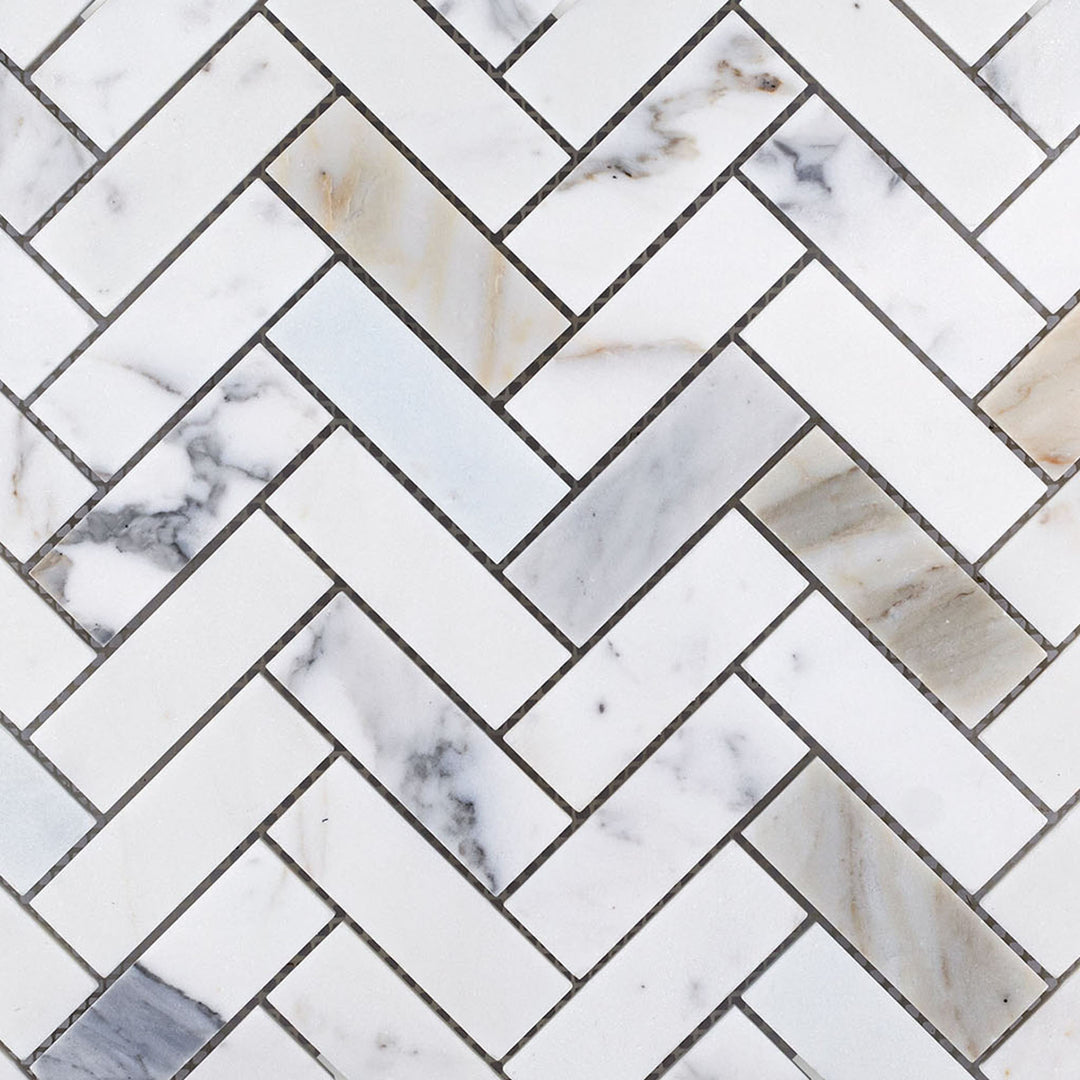 Wide view of Calacatta Gold Marble 1x3 herringbone honed mosaic revealing elongated geometry and warm veining.