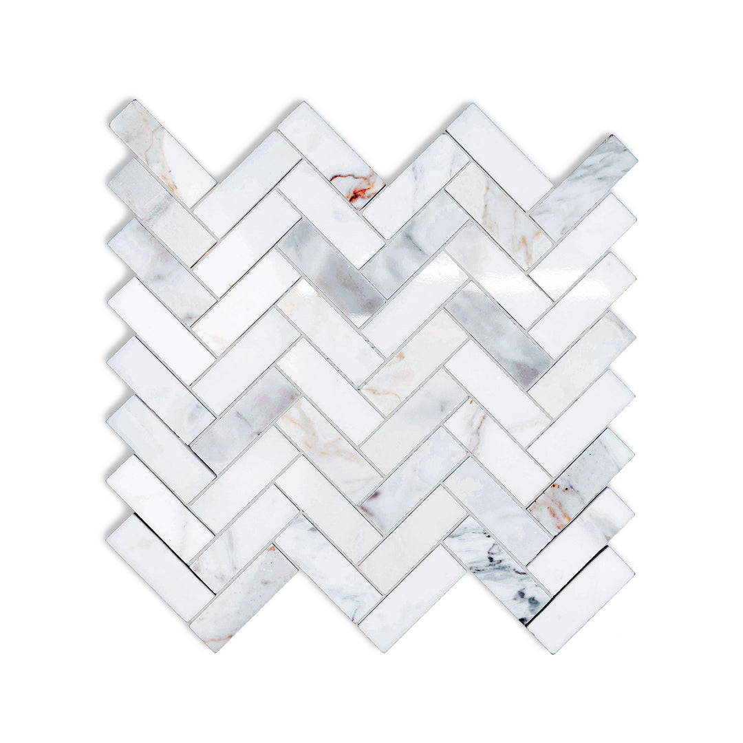 Polished Calacatta Gold Marble 1x3 herringbone mosaic seen from above, with sharp geometry and glossy finish that elevates any surface.