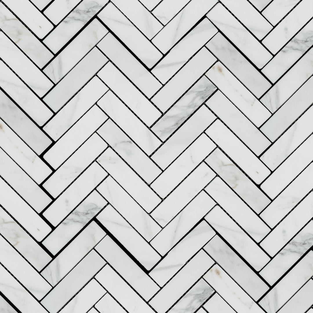 Calacatta Gold Marble 1x4 herringbone honed mosaic tiles arranged in a detailed overview that emphasizes linear flow.