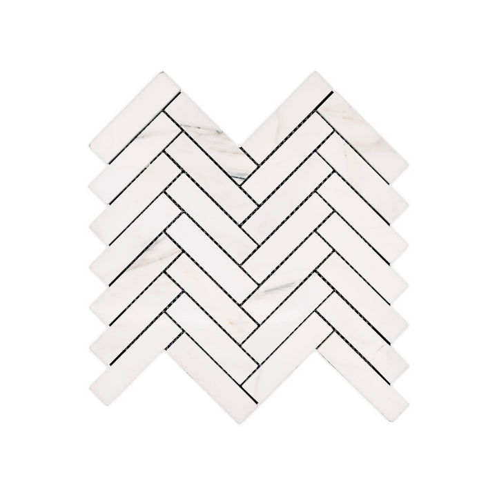 This top-view shot of polished 1x4 Calacatta Gold Marble herringbone mosaic reveals luxurious detail and brilliant veining across a sleek marble surface.