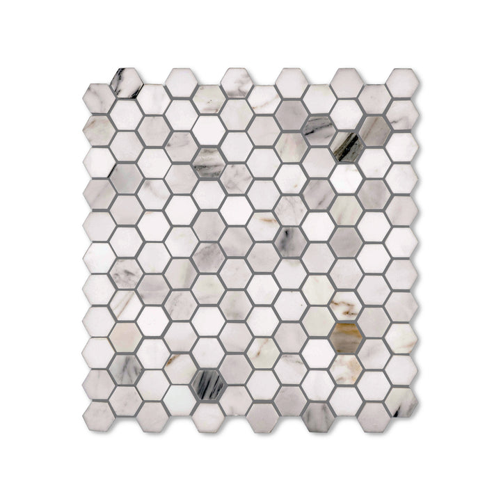 Top-down view of Calacatta Gold Marble 1 inch hexagon mosaic in a honed finish, featuring delicate veining and a soft matte surface for refined styling.