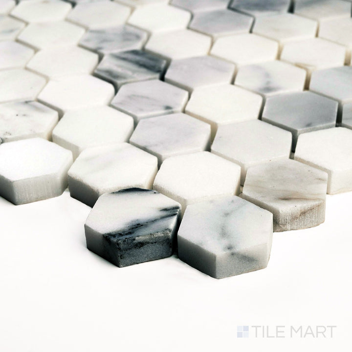 Corner close-up of Calacatta Gold Marble 1" hexagon polished mosaic showing rich gold veining and reflective surface.