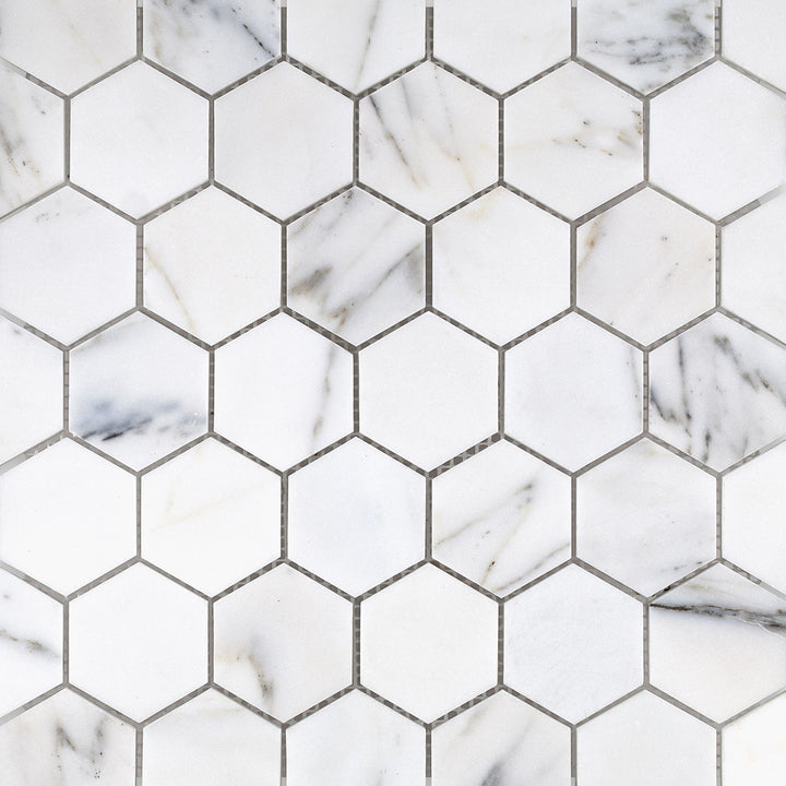 Calacatta Gold Marble 2" hexagon honed mosaic layout highlighting clean symmetry and soft matte tones.