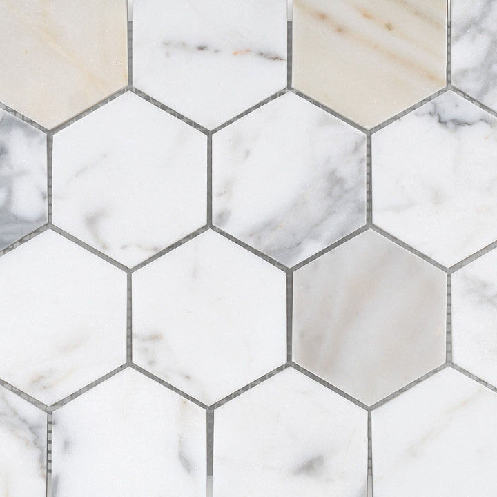 Detailed view of Calacatta Gold Marble 3" hexagon honed mosaic featuring larger scale geometry and muted elegance.